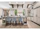 Bright kitchen boasts a large island, pendant lights and beams above an elegant range hood at 2891 E Alameda Ave, Denver, CO 80209