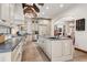 A chef's kitchen featuring custom cabinets, an island with seating, and a cozy dining area at 2891 E Alameda Ave, Denver, CO 80209