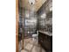 Stylish powder room with designer wallpaper, mirror, and dark vanity at 2891 E Alameda Ave, Denver, CO 80209