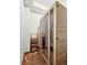 Home Sauna featuring wood-paneled walls, glass door, and brick flooring in a small room at 2891 E Alameda Ave, Denver, CO 80209