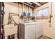 Basement laundry area with modern washer and dryer, utility sink, and storage at 42 S Moline St, Aurora, CO 80012