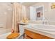 Bathroom with bathtub, shower, and a wooden vanity with a large mirror, toilet, and decorative accents at 42 S Moline St, Aurora, CO 80012