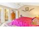 Bright bedroom featuring a vaulted ceiling, a ceiling fan, a dresser, and closet access at 42 S Moline St, Aurora, CO 80012