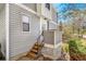 Gray two-story home with wood siding and wood steps leading to the front door at 42 S Moline St, Aurora, CO 80012