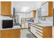 Charming kitchen with white cabinets, wooden trim, stainless appliances, and natural light from the skylight at 42 S Moline St, Aurora, CO 80012