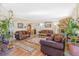 Open-concept living room leading to the dining area with hardwood floors and a stone fireplace at 42 S Moline St, Aurora, CO 80012