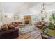 Spacious living room with a stone fireplace, hardwood floors, and sliding glass doors at 42 S Moline St, Aurora, CO 80012