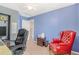 A home office with a calming atmosphere featuring a red chair and view into another room at 42 S Moline St, Aurora, CO 80012