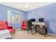 Comfortable home office space with bright window, ceiling fan, and a traditional-style red chair at 42 S Moline St, Aurora, CO 80012