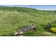 Stunning aerial view showcases the home's peaceful setting surrounded by lush greenery and rolling hills at 2605 Cactus Cir, Golden, CO 80401