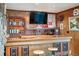 Basement bar featuring custom wood work, open shelving, and unique decor at 2605 Cactus Cir, Golden, CO 80401