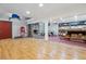 Open basement area with a stone fireplace, ping pong table, and red accent floor at 2605 Cactus Cir, Golden, CO 80401
