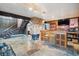 Basement bar area with wooden bar, stone fireplace and slate tile flooring at 2605 Cactus Cir, Golden, CO 80401