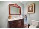 Bathroom featuring antique-style vanity with marble countertop and decorative mirror at 2605 Cactus Cir, Golden, CO 80401