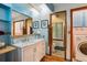 Unique bathroom with blue accents, a marble sink, and vintage-style saloon doors to an adjacent space at 2605 Cactus Cir, Golden, CO 80401