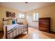 Cozy bedroom features a metal bed frame, wood floors, and ample natural light at 2605 Cactus Cir, Golden, CO 80401