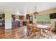 Open floor plan with dining table, chairs, and kitchen with wood cabinets at 2605 Cactus Cir, Golden, CO 80401