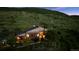 Inviting hillside home with warm interior lights and beautiful landscaping at twilight at 2605 Cactus Cir, Golden, CO 80401