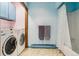 Well-lit laundry room with modern appliances and ample storage space, conveniently located near the bathroom at 2605 Cactus Cir, Golden, CO 80401