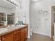 Well-lit bathroom featuring double vanity and glass shower at 9019 E Panorama Cir # D204, Englewood, CO 80112