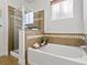 Bathroom featuring bathtub and tiled shower with glass door at 9019 E Panorama Cir # D204, Englewood, CO 80112