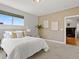 Cozy bedroom with adjacent view into living area and fireplace at 9019 E Panorama Cir # D204, Englewood, CO 80112