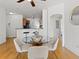 Cozy dining area with hardwood floors, a glass table, and seamless flow to the kitchen and living room at 9019 E Panorama Cir # D204, Englewood, CO 80112