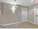 Well-lit hallway featuring neutral walls and carpet, complete with white doors and trim at 9019 E Panorama Cir # D204, Englewood, CO 80112