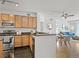 Open kitchen and dining area with stainless steel appliances and breakfast bar at 9019 E Panorama Cir # D204, Englewood, CO 80112