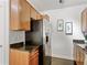 Well-lit kitchen featuring stainless steel refrigerator and granite counters at 9019 E Panorama Cir # D204, Englewood, CO 80112