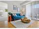 Comfortable living room features modern furnishings, area rug, and natural light with a balcony view at 9019 E Panorama Cir # D204, Englewood, CO 80112