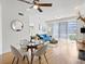 Open-concept living space with dining area, living room, and abundant natural light, perfect for modern living at 9019 E Panorama Cir # D204, Englewood, CO 80112