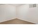 Empty bedroom with neutral carpet, bright white walls, and a small window at 6933 S Dahlia St, Centennial, CO 80122