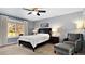 Serene bedroom with a queen-sized bed, a ceiling fan, and a large window at 6933 S Dahlia St, Centennial, CO 80122