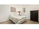 Carpeted bedroom with a warm lamp, dark dresser and comfortable bed at 6933 S Dahlia St, Centennial, CO 80122