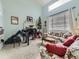 Living room with floral sofa, piano, and fireplace at 4936 Stoneham Ave, Castle Rock, CO 80104