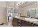 Well-lit bathroom with double sinks, neutral finishes, and a calming ambiance at 2405 Calais Dr # 18A, Longmont, CO 80504