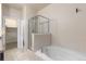 Relaxing bathroom with a soaking tub, a separate glass-enclosed shower, and modern fixtures at 2405 Calais Dr # 18A, Longmont, CO 80504