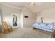 Bright bedroom featuring outside access, a rocking chair, and a comfortable layout at 2405 Calais Dr # 18A, Longmont, CO 80504