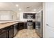 Efficient kitchen featuring modern stainless steel appliances, dark cabinets, and easy access at 2405 Calais Dr # 18A, Longmont, CO 80504