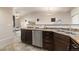 Charming kitchen with dark wood cabinetry, stainless steel appliances, and a view to the living area at 2405 Calais Dr # 18A, Longmont, CO 80504
