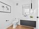 Stylish powder room with modern fixtures, floating vanity, round mirror, and neutral decor at 1601 Park Ave # 212, Denver, CO 80218