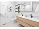 Modern bathroom with a double sink vanity, floating wood drawers, and stylish black fixtures at 1601 Park Ave # 212, Denver, CO 80218