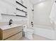 Cozy bathroom featuring single sink vanity and soaking tub with modern, sleek shelving at 1601 Park Ave # 212, Denver, CO 80218