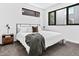 Cozy bedroom with large bed, modern lighting, neutral tones, and natural light at 1601 Park Ave # 212, Denver, CO 80218