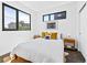 Bright bedroom with large windows, two side tables, stylish lamps, and modern decorations at 1601 Park Ave # 212, Denver, CO 80218