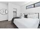 Bright bedroom with a large bed, modern decor, neutral colors, and a walk-in closet at 1601 Park Ave # 212, Denver, CO 80218