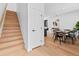 Bright dining room with wood floors and a modern light fixture at 1601 Park Ave # 212, Denver, CO 80218
