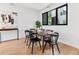 Modern dining room featuring hardwood floors, a dining table, and natural light from the window at 1601 Park Ave # 212, Denver, CO 80218