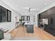 Open-concept living space with kitchen, dining and living room featuring modern finishes and hardwood floors at 1601 Park Ave # 212, Denver, CO 80218